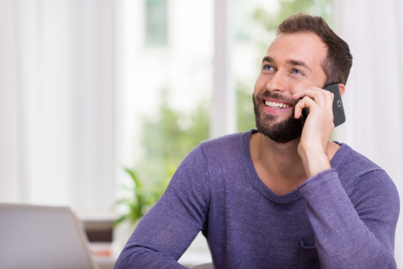 Man Smiling On Phone